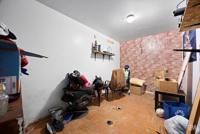 basement with a textured ceiling and brick wall