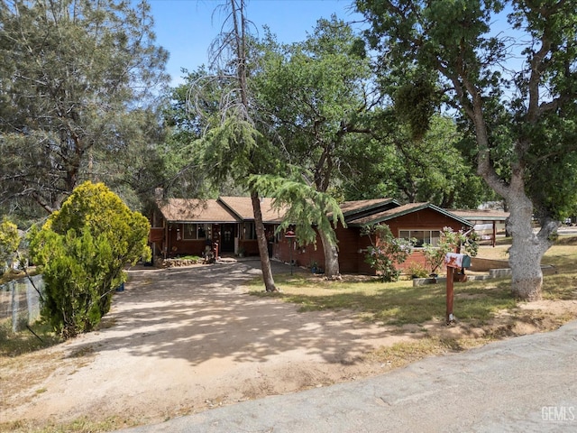 single story home with aphalt driveway