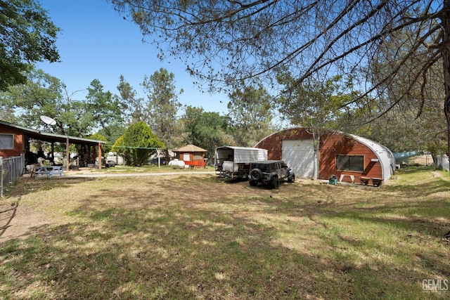 view of yard with an outdoor structure and a detached garage