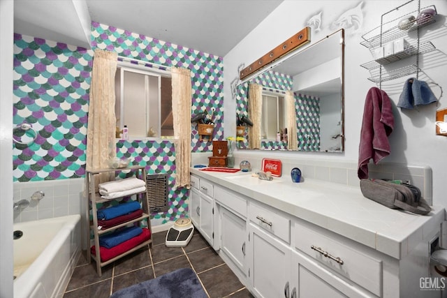 full bathroom featuring a bathing tub, tile patterned floors, wallpapered walls, and vanity