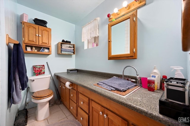 bathroom with vanity, tile patterned floors, and toilet