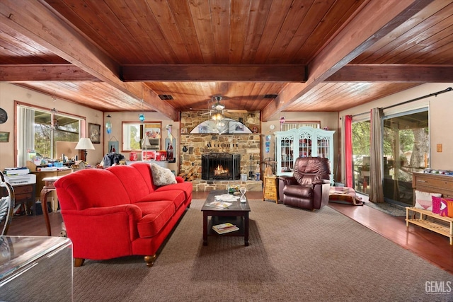 living room featuring ceiling fan, beamed ceiling, and a wealth of natural light