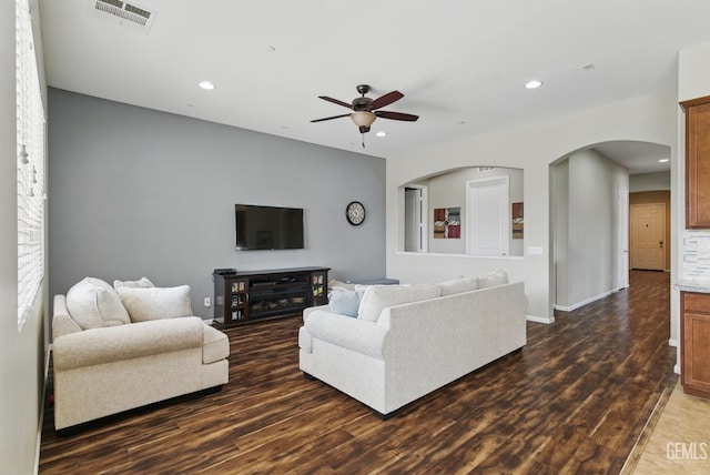 3420 Palagetto Pl, Bakersfield, CA 93314 - living room with a ceiling fan, recessed lighting, dark wood-style floors, arched walkways, and baseboards
