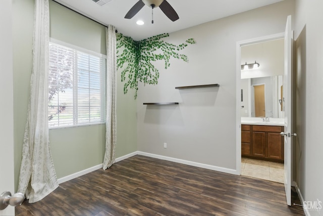 3420 Palagetto Pl, Bakersfield, CA 93314 - unfurnished bedroom with baseboards, wood finished floors, recessed lighting, connected bathroom, and a sink