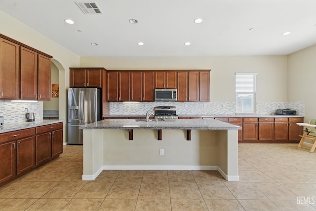 3420 Palagetto Pl, Bakersfield, CA 93314 - kitchen featuring stainless steel appliances, tasteful backsplash, stone countertops, light tile patterned floors, and recessed lighting