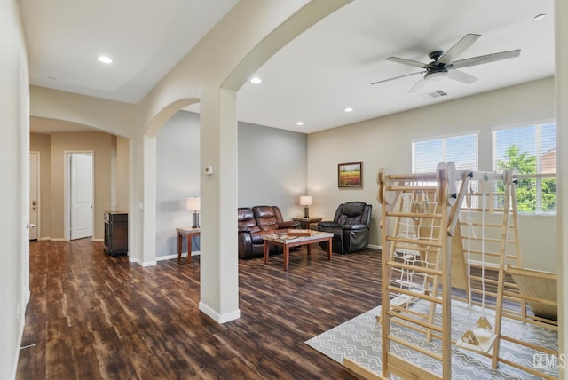 3420 Palagetto Pl, Bakersfield, CA 93314 - living area with arched walkways, dark wood finished floors, a ceiling fan, baseboards, and recessed lighting