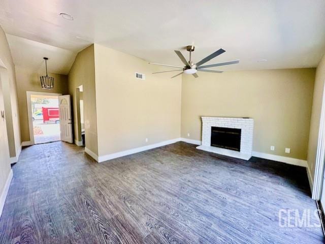 2004 Magdelena Ave, Bakersfield, CA 93307 - unfurnished living room featuring dark wood-type flooring, ceiling fan, a brick fireplace, baseboards, and vaulted ceiling