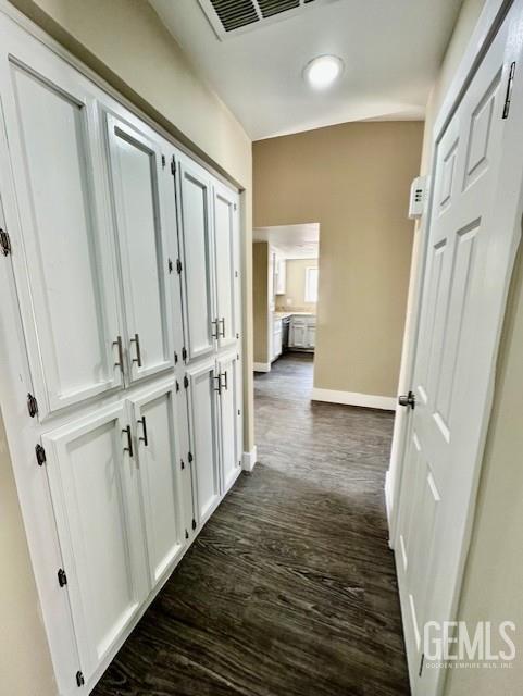 2004 Magdelena Ave, Bakersfield, CA 93307 - corridor with dark wood-type flooring and baseboards