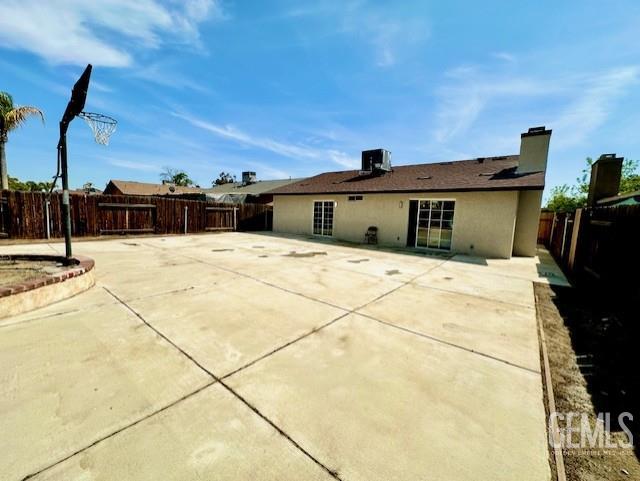 2004 Magdelena Ave, Bakersfield, CA 93307 - back of house featuring a fenced backyard, a patio area, and central air condition unit