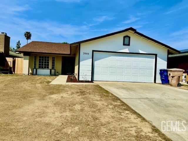 2004 Magdelena Ave, Bakersfield, CA 93307 - ranch-style house featuring concrete driveway, an attached garage, and stucco siding