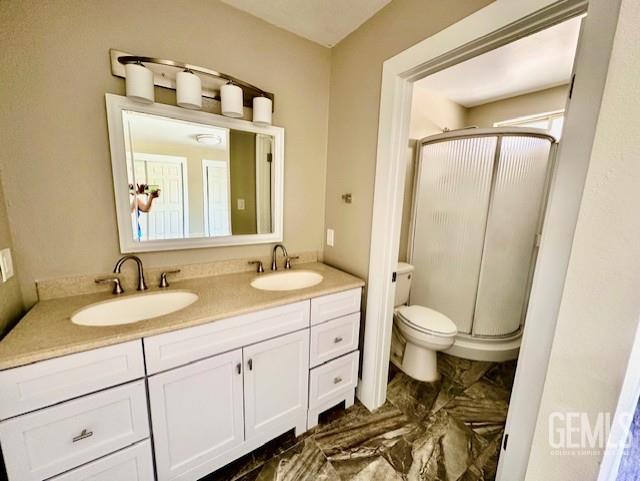 2004 Magdelena Ave, Bakersfield, CA 93307 - full bath featuring a stall shower, double vanity, and toilet