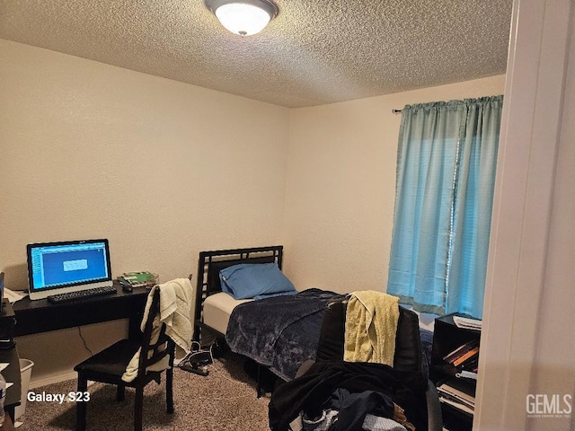 bedroom with carpet flooring and a textured ceiling