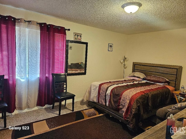 carpeted bedroom with a textured ceiling