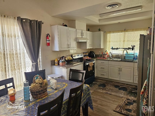 kitchen with black electric range, white cabinets, dark hardwood / wood-style floors, and sink