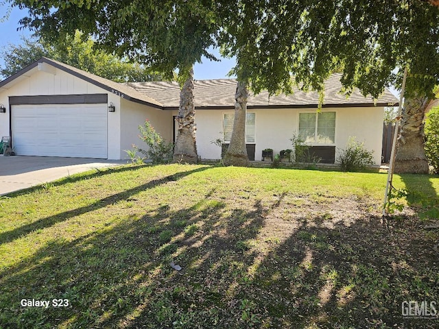 ranch-style house featuring a garage and a front lawn