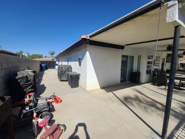 view of patio / terrace featuring a grill, fence, and ceiling fan