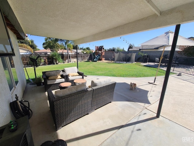 view of patio / terrace featuring outdoor lounge area, a playground, and a fenced backyard