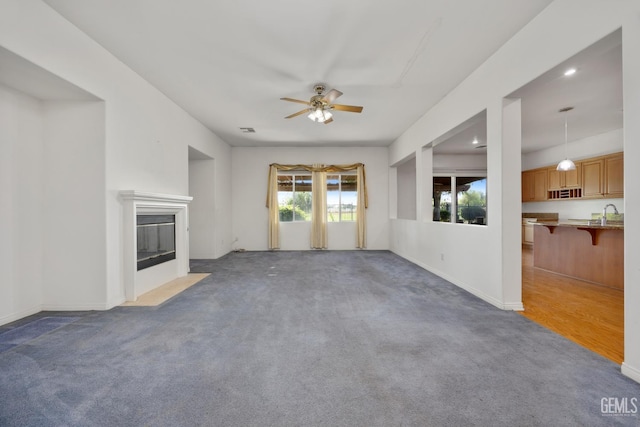 4702 Aviara Dr, Bakersfield, CA 93312 - unfurnished living room with ceiling fan, carpet floors, a fireplace with flush hearth, recessed lighting, and baseboards