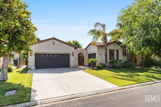 4702 Aviara Dr, Bakersfield, CA 93312 - mediterranean / spanish home with stucco siding, a garage, driveway, a front yard, and a gate