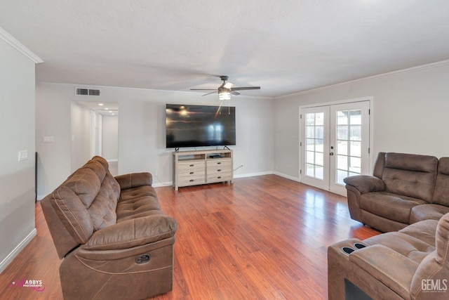 living room featuring ceiling fan, wood-type flooring, crown molding, and french doors