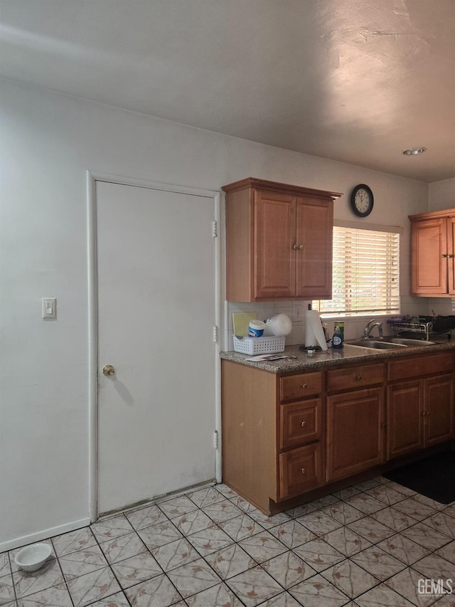 kitchen featuring backsplash and sink