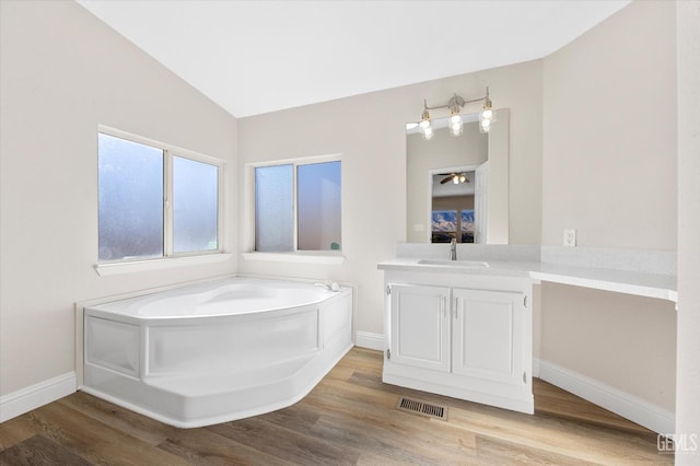 4500 Joshua Dr, Mountain Mesa, CA 93240 - full bath featuring vanity, a bath, wood finished floors, vaulted ceiling, and a ceiling fan