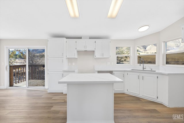 4500 Joshua Dr, Mountain Mesa, CA 93240 - kitchen featuring light wood finished floors, a center island, and white cabinets