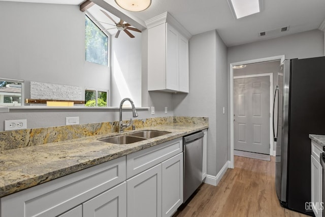 8000 Kroll Way Unit 29, Bakersfield, CA 93311 - kitchen with stainless steel appliances, a sink, a ceiling fan, light wood-type flooring, and white cabinetry