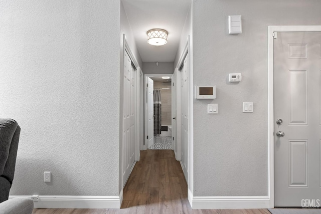 8000 Kroll Way Unit 29, Bakersfield, CA 93311 - corridor featuring wood finished floors, a textured wall, and baseboards