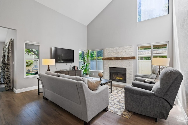 8000 Kroll Way Unit 29, Bakersfield, CA 93311 - living room featuring high vaulted ceiling, wood-type flooring, a stone fireplace, baseboards, and healthy amount of natural light