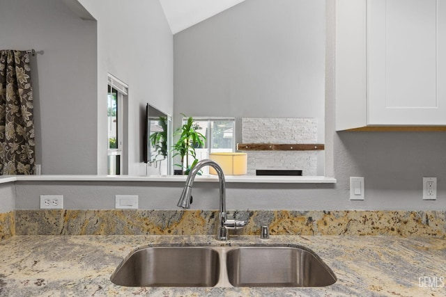 8000 Kroll Way Unit 29, Bakersfield, CA 93311 - kitchen with a sink, light stone countertops, lofted ceiling, and white cabinets