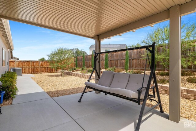 view of patio with central AC unit and a fenced backyard