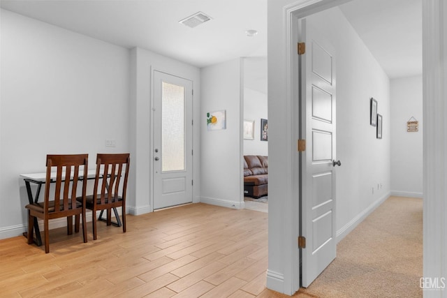 entrance foyer with baseboards, visible vents, and light wood finished floors