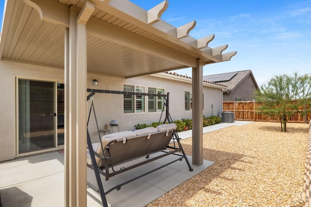 view of patio / terrace featuring fence and central AC unit