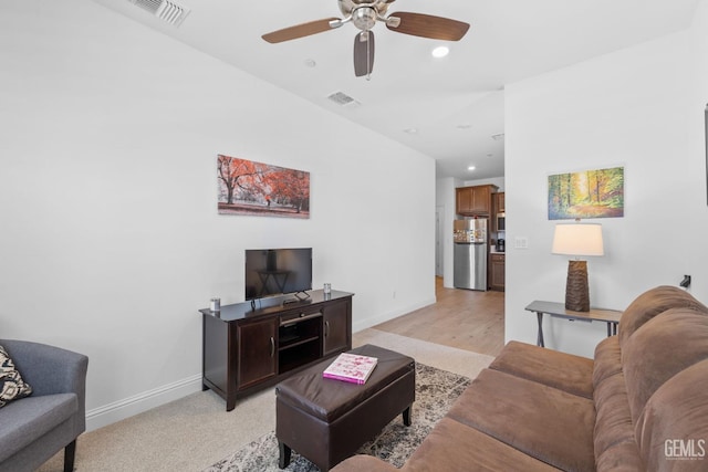 living room with a ceiling fan, baseboards, and visible vents
