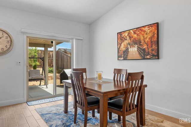 dining area featuring baseboards and light wood-style floors