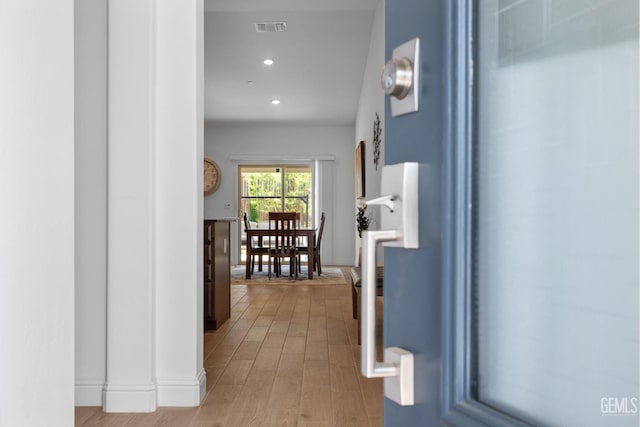 corridor with recessed lighting, visible vents, and light wood-style floors