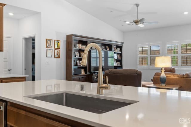 kitchen with open floor plan, a ceiling fan, and light countertops
