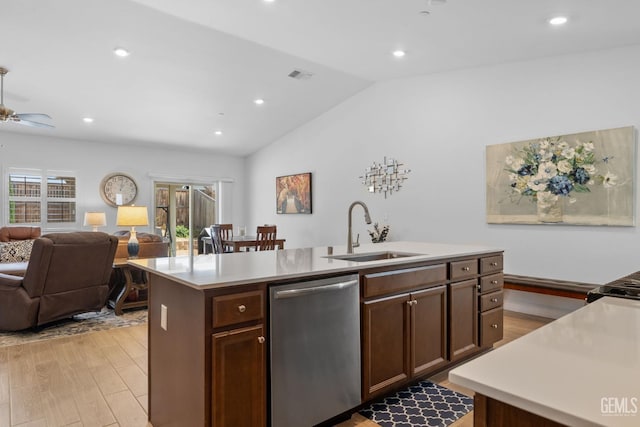 kitchen with a sink, light wood-style floors, dishwasher, open floor plan, and a center island with sink