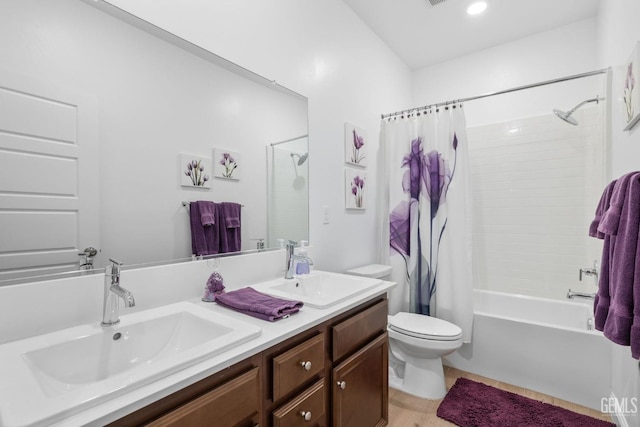 full bath featuring double vanity, toilet, a sink, and shower / tub combo