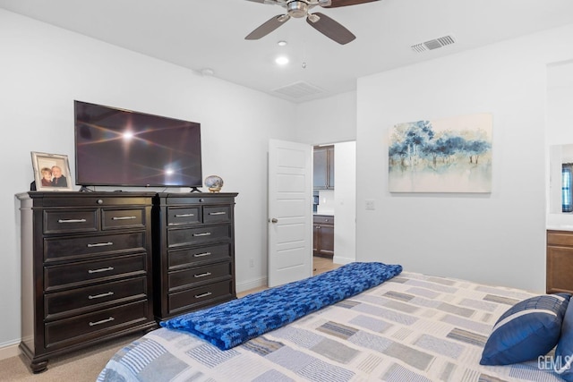 bedroom with visible vents, baseboards, ceiling fan, light colored carpet, and connected bathroom