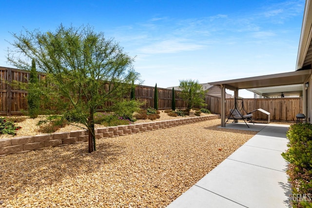 view of yard with a fenced backyard, a ceiling fan, and a patio