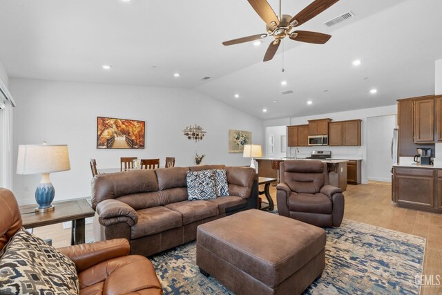 3308 Whispering Brook Ln, Shafter, CA 93263 - living area with light wood-style flooring, a ceiling fan, recessed lighting, vaulted ceiling, and visible vents
