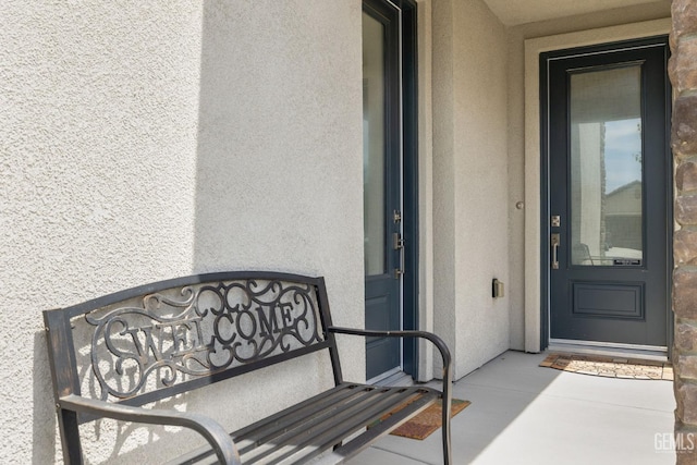 view of exterior entry with stucco siding
