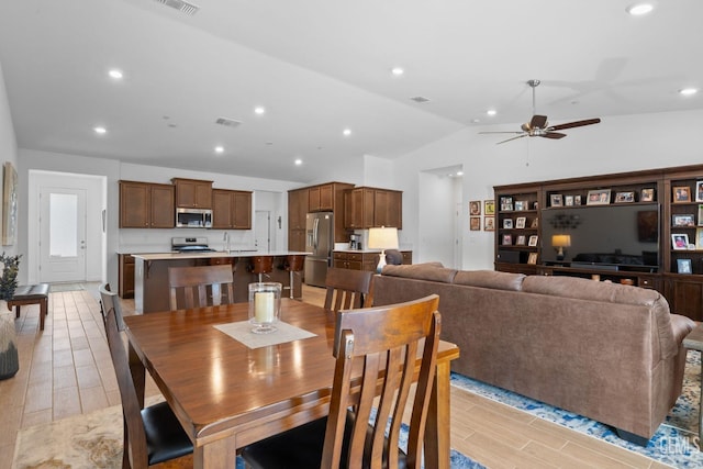 dining space with wood tiled floor, a ceiling fan, vaulted ceiling, and recessed lighting