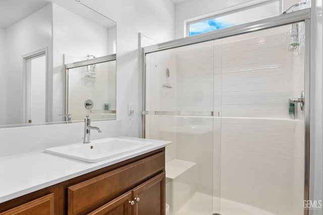bathroom with vanity and a shower stall