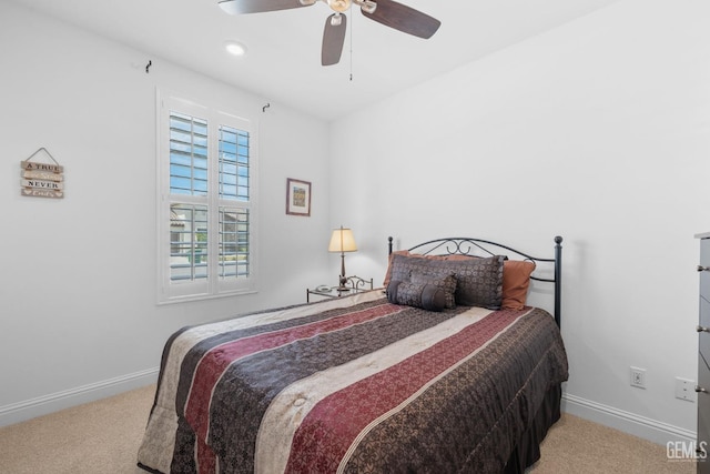 carpeted bedroom with baseboards and a ceiling fan