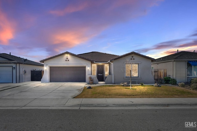 view of front of home with a yard and a garage