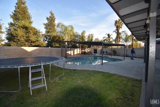 view of swimming pool with a trampoline, a fenced in pool, a yard, a patio, and a fenced backyard