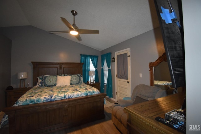 bedroom featuring lofted ceiling, ceiling fan, and light wood finished floors